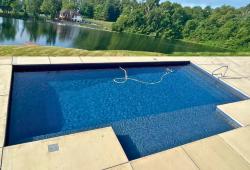 Large rectangle with vinyl covered steps, side sun ledge and bench continuing into the deep end, a perfect setup for those little beginner swimmers
